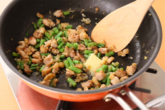 玉ねぎはみじん切りに、いんげんは幅1～2センチに切る。トマトは1センチ角に切る。鶏肉は小さめの一口大に切り、塩、こしょう各少々をふる。フライパンにサラダ油大さじ1と1/2を中火で熱し、鶏肉、玉ねぎ、いんげんを炒める。鶏肉の色が変わったらバターを加える。